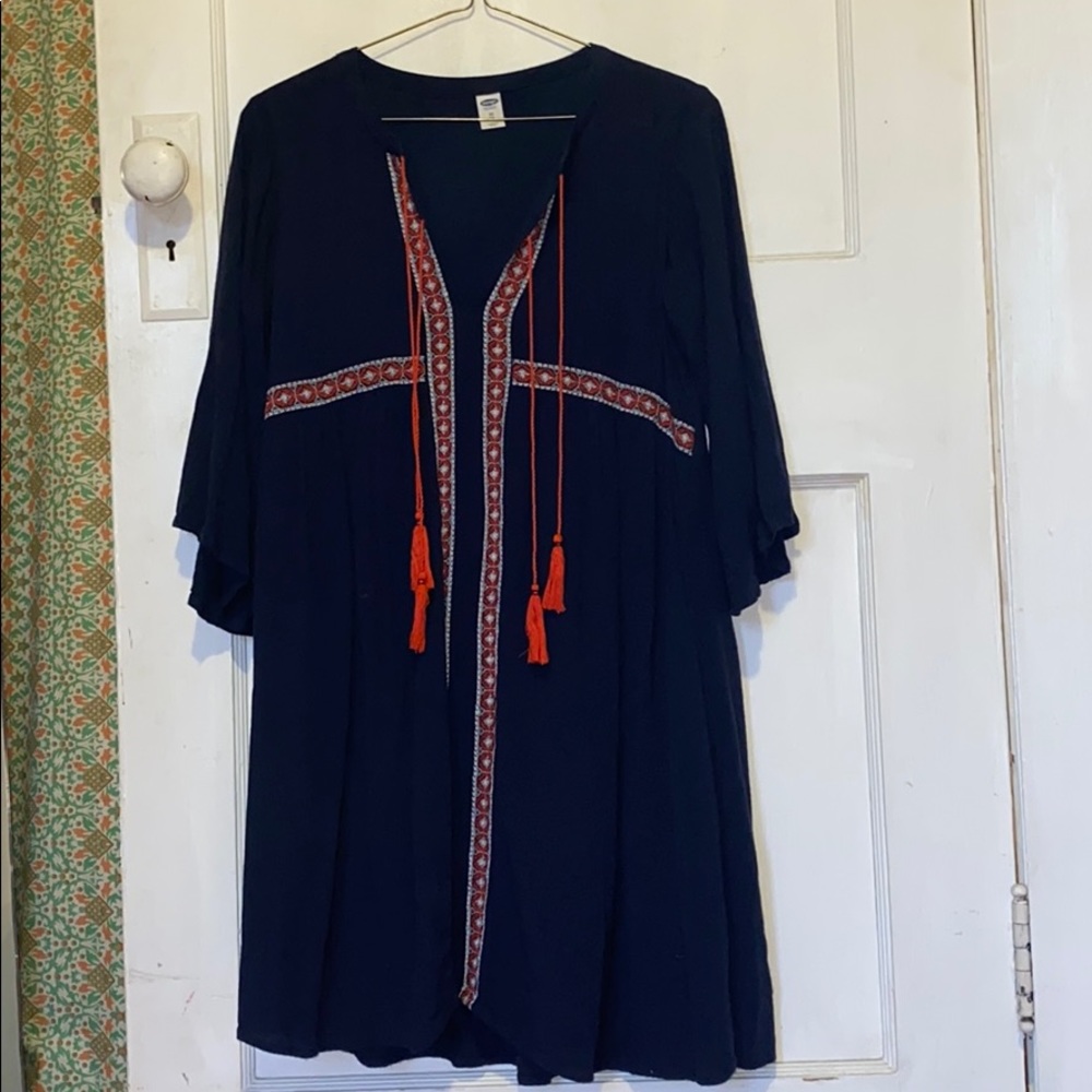 boho navy dress with orange stitching and tassels